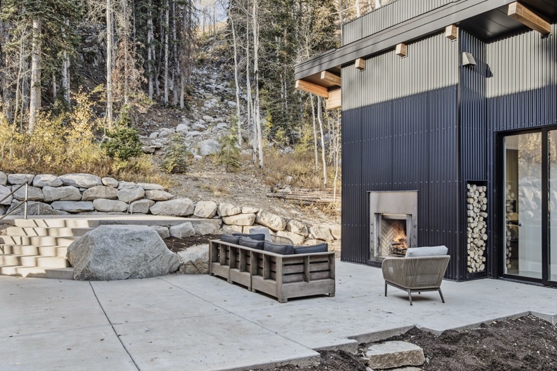 Patio with seating and fireplace